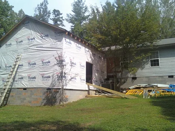 Tyvek wrapped gable on a new room addition beside an existing home in Archer